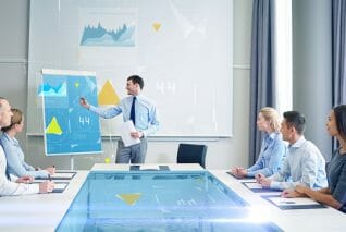 business, people and teamwork concept - group of smiling businesspeople with virtual charts projection meeting on presentation in office