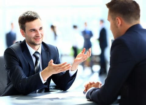Happy business people talking on meeting at office
